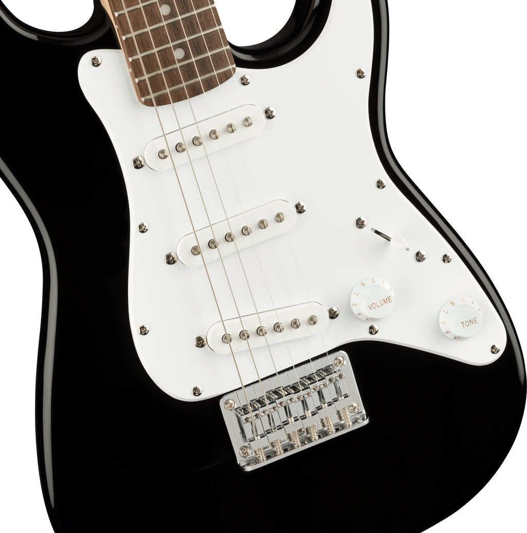 Fender Squier Mini Stratocaster electric guitar with black body and laurel fretboard, close-up view of the guitar's neck and fretboard.