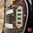 Black Squier Classic Vibe Bass VI guitar with laurel fretboard, showing the full body and neck on a plain background.