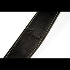 Black Fender leather guitar strap with adjustable length and padded design for comfortable playing.