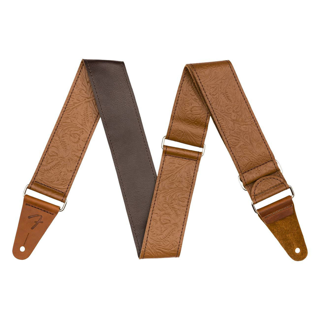 Fender brown tooled leather guitar strap with intricate embossed design, 2-inch width, adjustable for comfortable playing.
