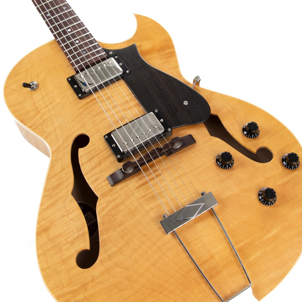 Heritage Standard H-575 hollow electric guitar in antique natural finish, showing its body and neck detail.