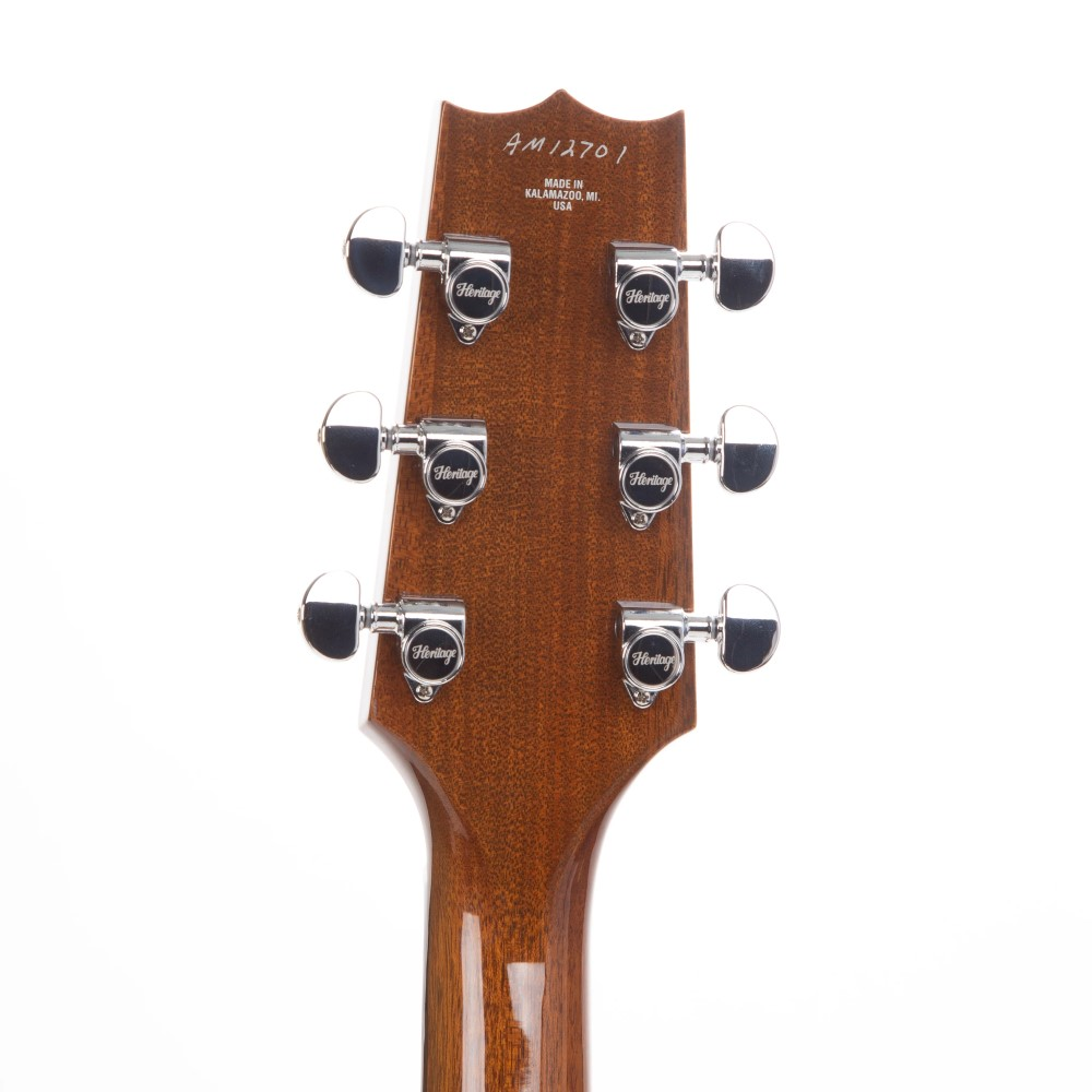Heritage Standard H-575 hollow electric guitar in antique natural finish, showing the body and neck with detailed wood grain.