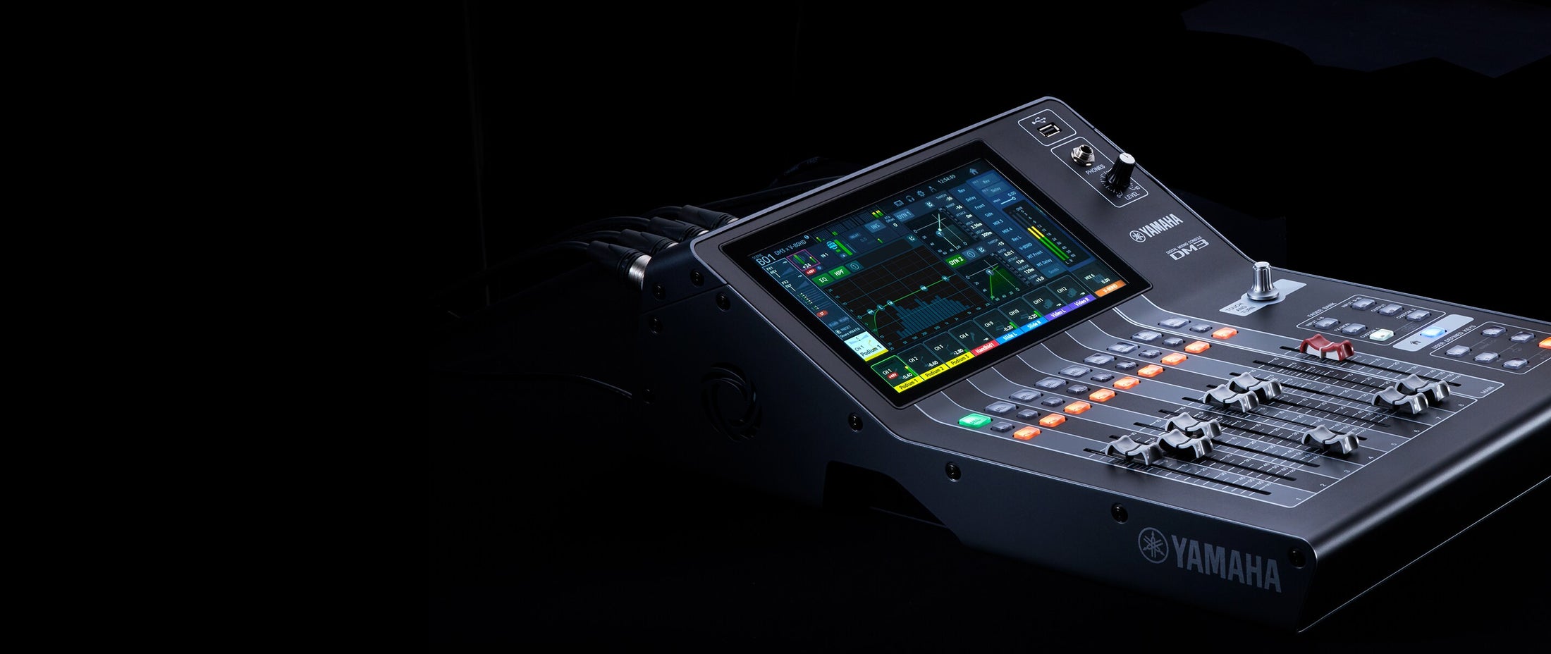 Yamaha audio mixing console with digital display on a dark background