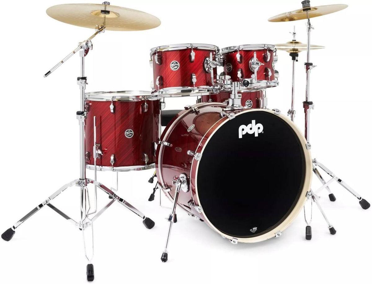 PDP Mainstage Twisted Cherry 5-piece drum kit with hardware, cymbals, and drum throne set up in a music studio.