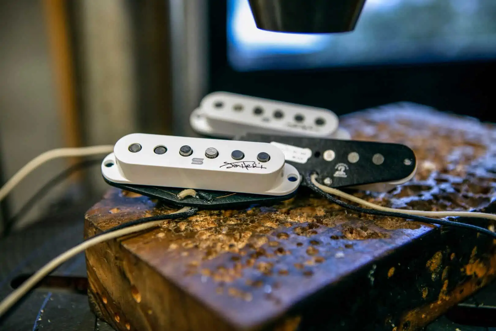 Seymour Duncan Hendrix Strat pickup set in white, showing close-up of magnetic pickups designed for electric guitar.