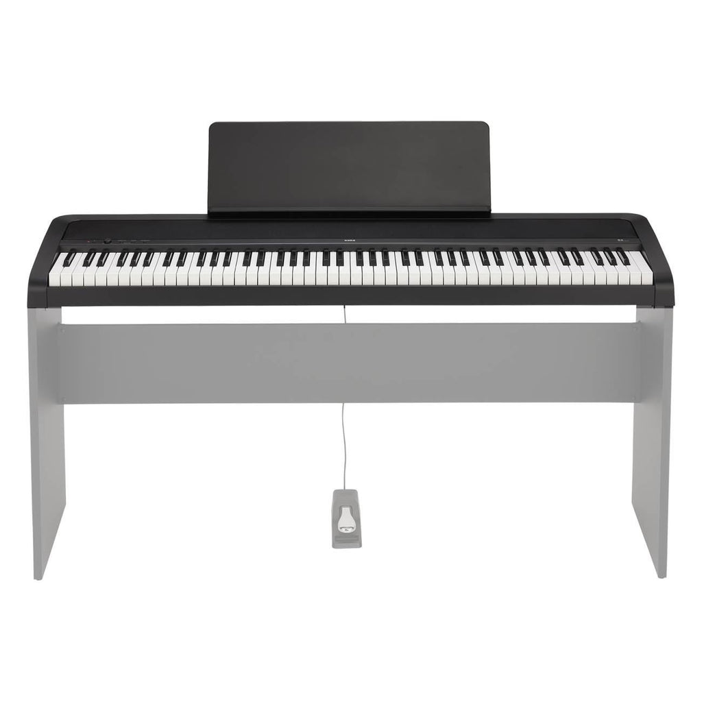 Korg B2 88-note weighted hammer action digital piano in black with control buttons and keyboard keys visible.