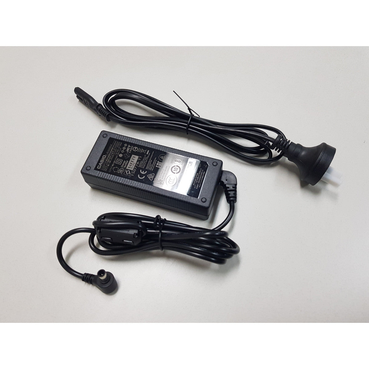 Casio AC Adapter for PXS6000 and PXS7000 keyboard, power supply with cord and plug, brand logo visible in the image.