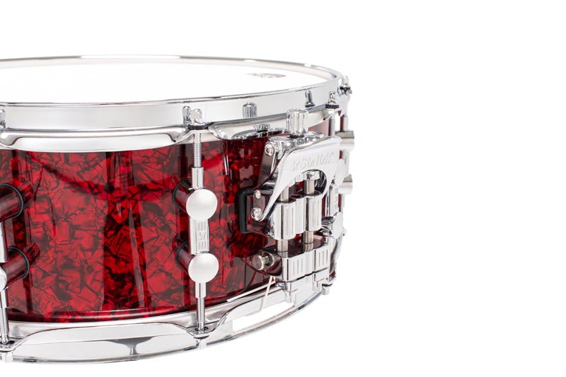 SONOR Momentum Birch 14x5.75-inch red pearl snare drum with polished metal hardware and textured finish.