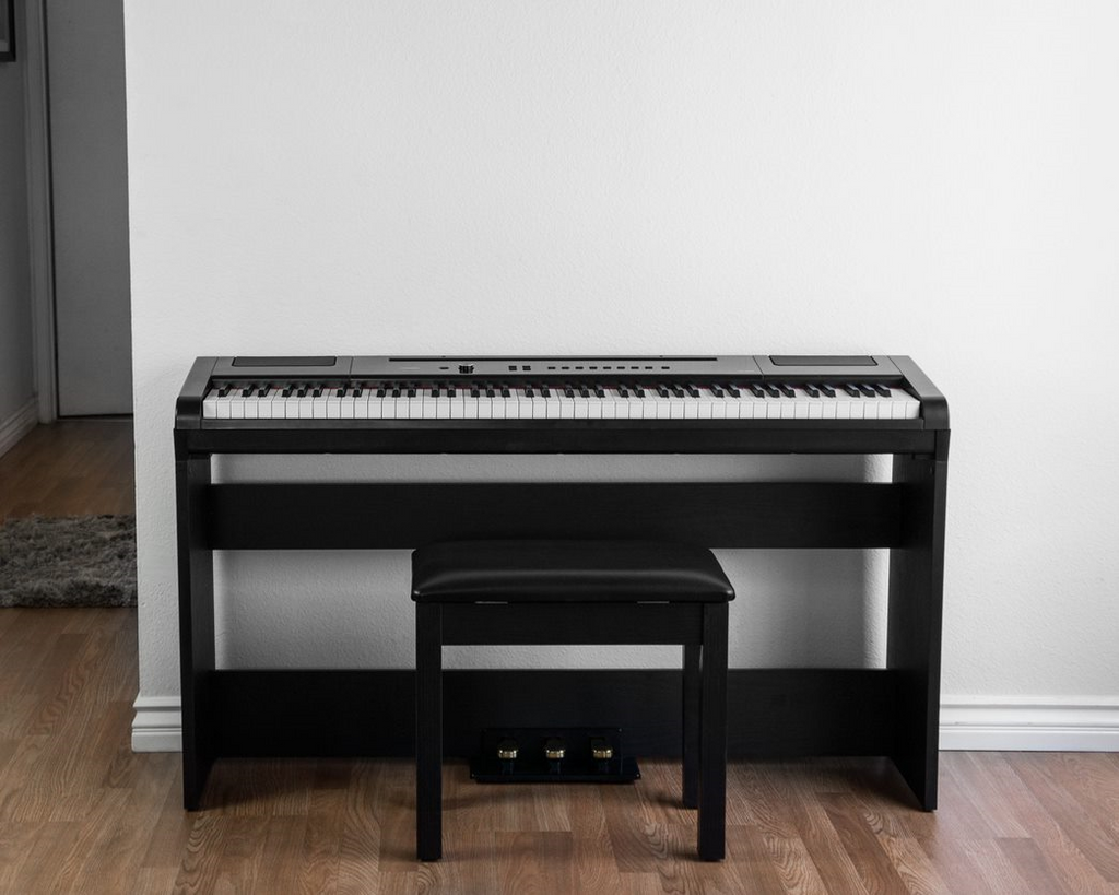 Artesia DP-3 digital piano with matching bench in a polished rosewood finish, featuring full keys and control panel.