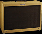 Fender Blues Deluxe Reissue guitar amplifier with vintage-style control panel and speaker grille, placed on a wooden floor.