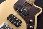 Reverend Mercalli 4 Natural bass guitar with a sleek wood finish and modern design, showing the body and neck details.