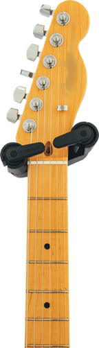 Hercules GS412BSW guitar stand holding an electric guitar with a sturdy black and silver design for secure support.