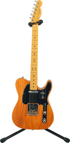 Hercules GS412BSW guitar stand holding a black electric guitar, featuring padded supports and sturdy metal construction.