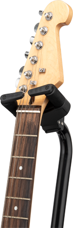 Hercules GS414BSW guitar stand holding an electric guitar, black metal frame with padded support arms for secure placement.