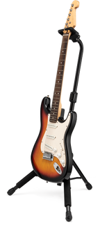 Hercules GS414BSW guitar stand holding an electric guitar, featuring a sturdy black frame and padded support for secure placement.