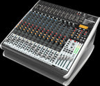 Behringer Xenyx QX2442USB analog mixer with multiple channels, knobs, and USB port for audio mixing and recording.
