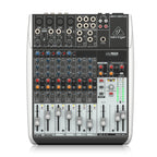 Behringer Xenyx Q1204USB analogue mixer with multiple input channels, knobs, and USB port for audio recording and mixing.
