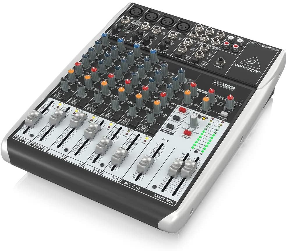 Behringer Xenyx Q1204USB analogue mixer with multiple input channels and control knobs, used for audio mixing and sound management.