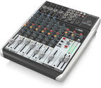 Behringer Xenyx Q1204USB analogue mixer with multiple input channels and control knobs, used for audio mixing and sound management.