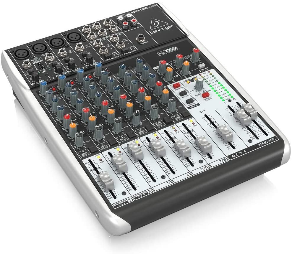Behringer Xenyx Q1204USB analogue mixer with multiple channels, knobs, and USB port for audio mixing and recording.