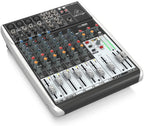 Behringer Xenyx Q1204USB analogue mixer with multiple channels, knobs, and USB port for audio mixing and recording.