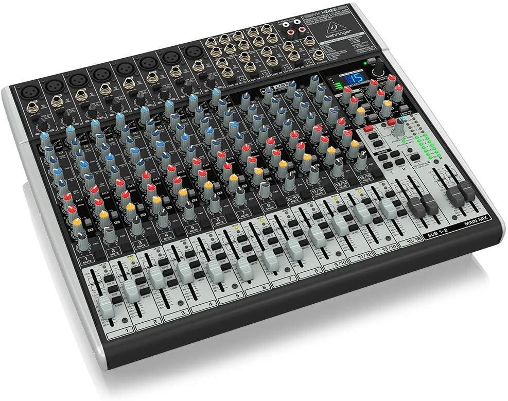 Behringer Xenyx X2222USB analogue mixer with multiple input channels, knobs, and USB connection for audio mixing and recording.
