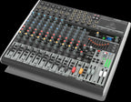 Behringer Xenyx X1832USB analogue mixer with multiple channels, knobs, and input jacks for audio mixing and sound control.