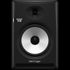 Behringer NEKKST K8 8-inch studio monitor speaker, front view showing sleek black design and speaker grille.
