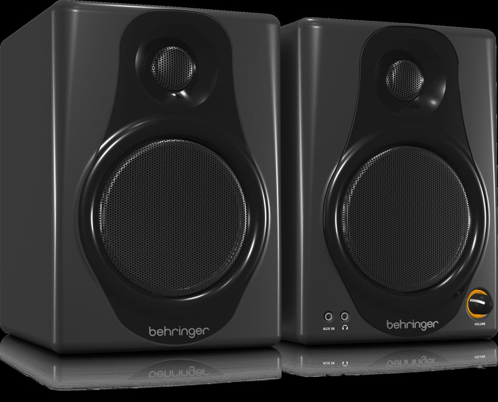Behringer Media 40USB 4-inch studio monitor speakers pair, showing black speakers with control knobs and cables for professional audio.