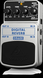 Behringer DR600 digital reverb effects pedal with control knobs and input/output jacks on a pedalboard.