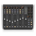Behringer X-Touch Compact USB controller keyboard with knobs and buttons for music production and digital audio control.