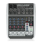 Behringer Xenyx QX602MP3 analogue mixer with multiple channels, knobs, and input jacks for audio mixing and sound control.