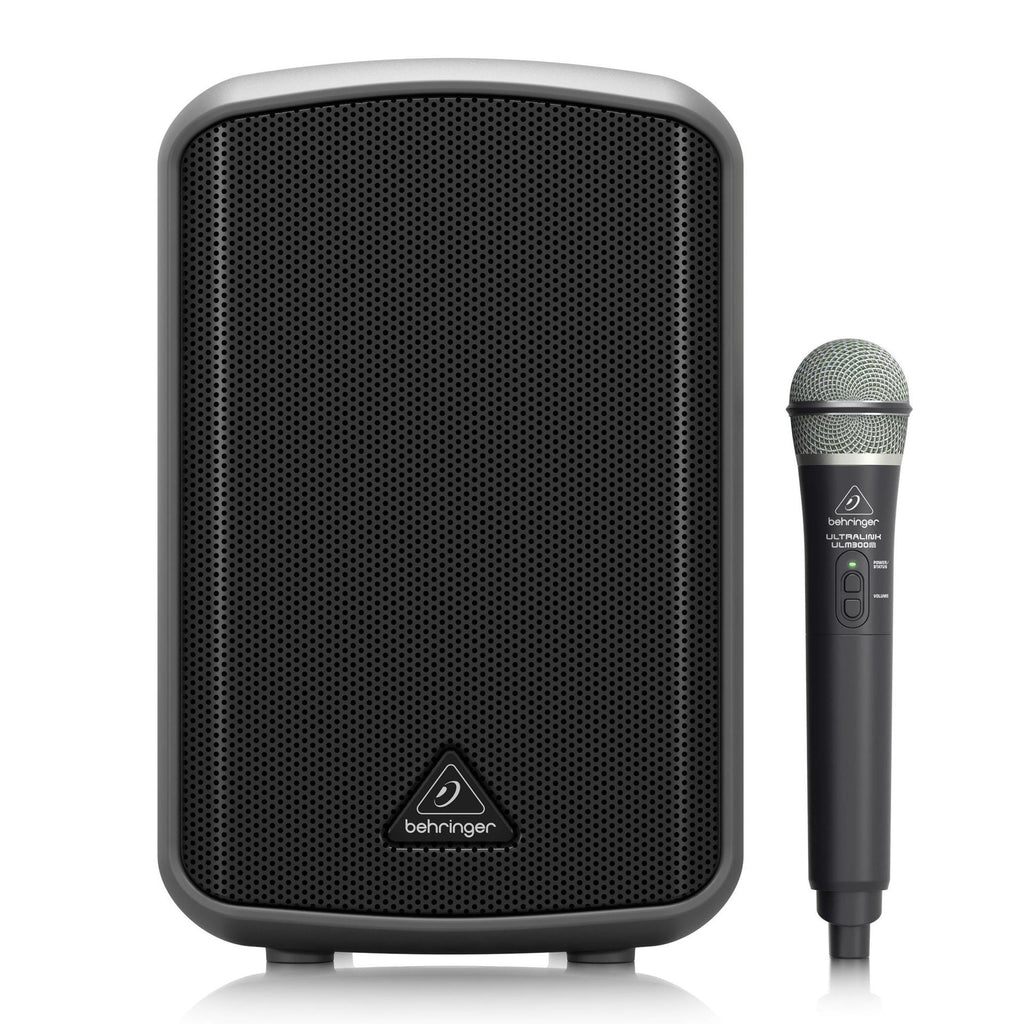 Behringer Europort MPA100BT portable PA system with microphone and speaker setup in a performance setting.