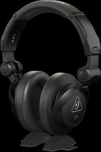 Behringer HC200 DJ studio closed-back headphones with padded ear cups and adjustable headband on a white background.