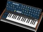 Behringer Monopoly analog polyphonic synthesizer keyboard with vintage-style control panel and multiple knobs and switches.