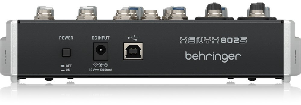 Behringer XENYX 802S analog 8-channel mixer with USB streaming interface, featuring knobs and input ports on a black control surface.