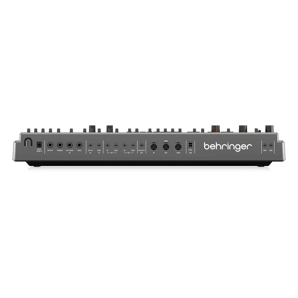 Behringer MS-1 MK II-GY analog synthesizer keyboard with gray finish and control knobs displayed on a wooden surface.