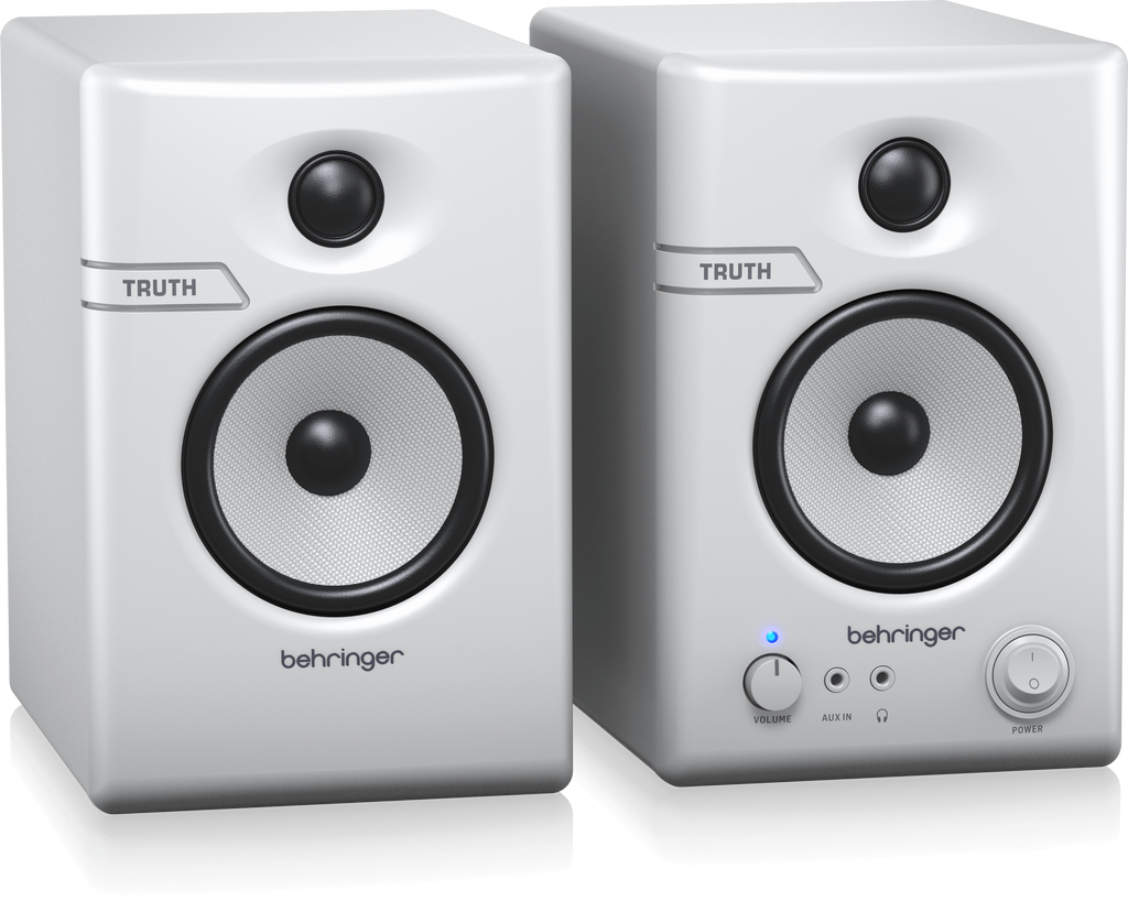 Pair of Behringer Truth 3.5 studio monitor speakers in white with Bluetooth connectivity, showing their front view.