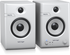 Pair of Behringer Truth 4.5 studio monitor speakers in white with Bluetooth connectivity, showing their front design and controls.
