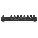 Behringer BCR32 MIDI controller with USB and MIDI ports, featuring rotary knobs and sliders for music production and control.