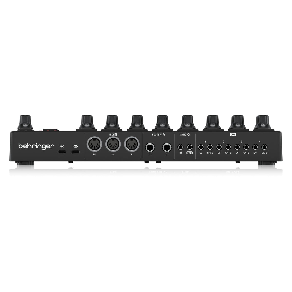 Behringer BCR32 MIDI controller with USB and MIDI ports, featuring rotary knobs and sliders for music production and control.