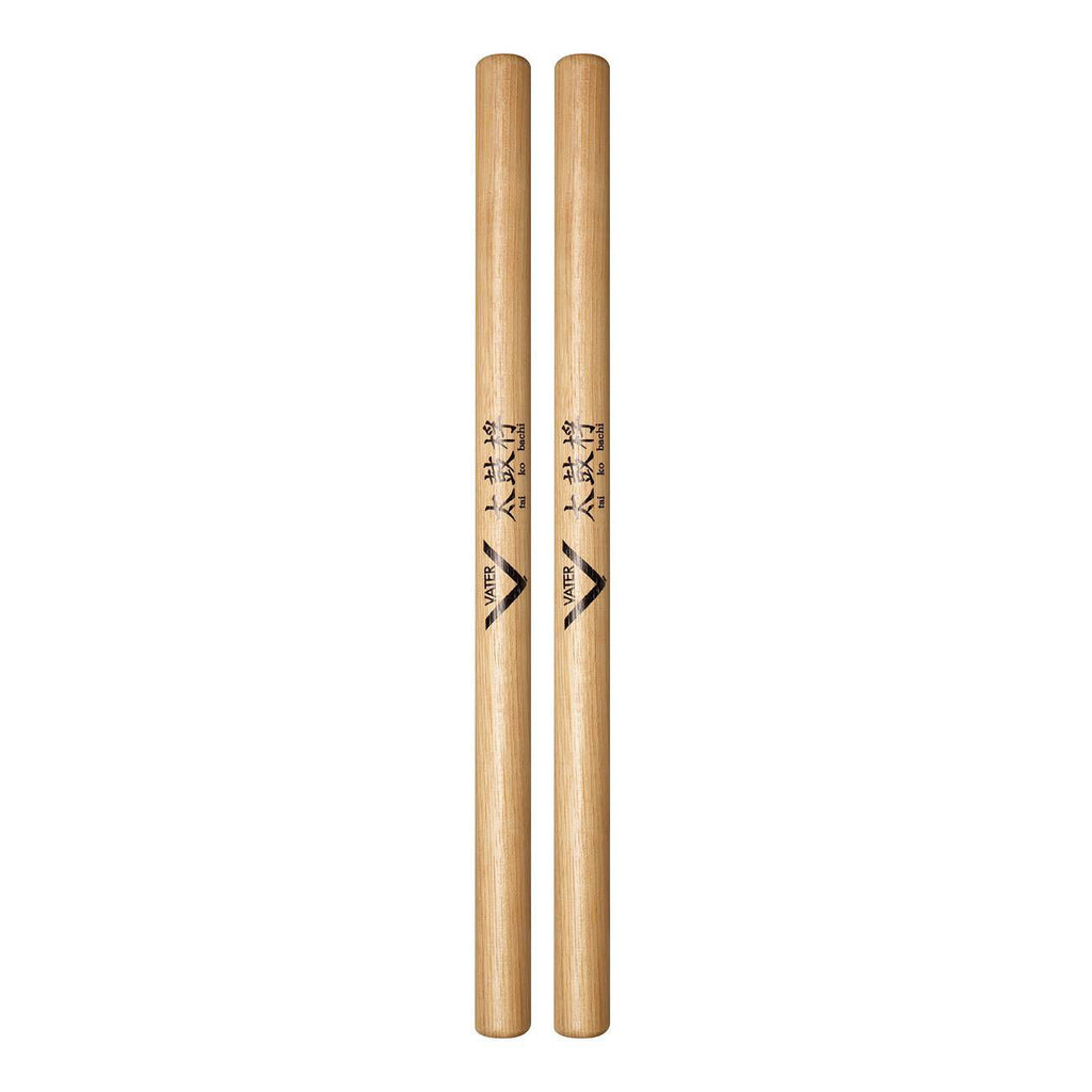Vater VHTKBW Tai Ko Bachi drumsticks with wooden handles for percussion playing, shown resting on a drum kit.