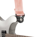 D'Addario Auto Lock guitar strap in new rose color, adjustable with secure locking mechanism for electric or acoustic guitars.