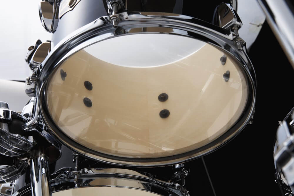 Tama Imperialstar 6-piece drum kit in Hairline Black with 22, 16, 14, 12, 10-inch drums and 14-inch snare, viewed from the side.