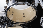 Tama Imperialstar 6-piece drum kit in Hairline Black with 22, 16, 14, 12, 10-inch drums and 14-inch snare, viewed from the side.