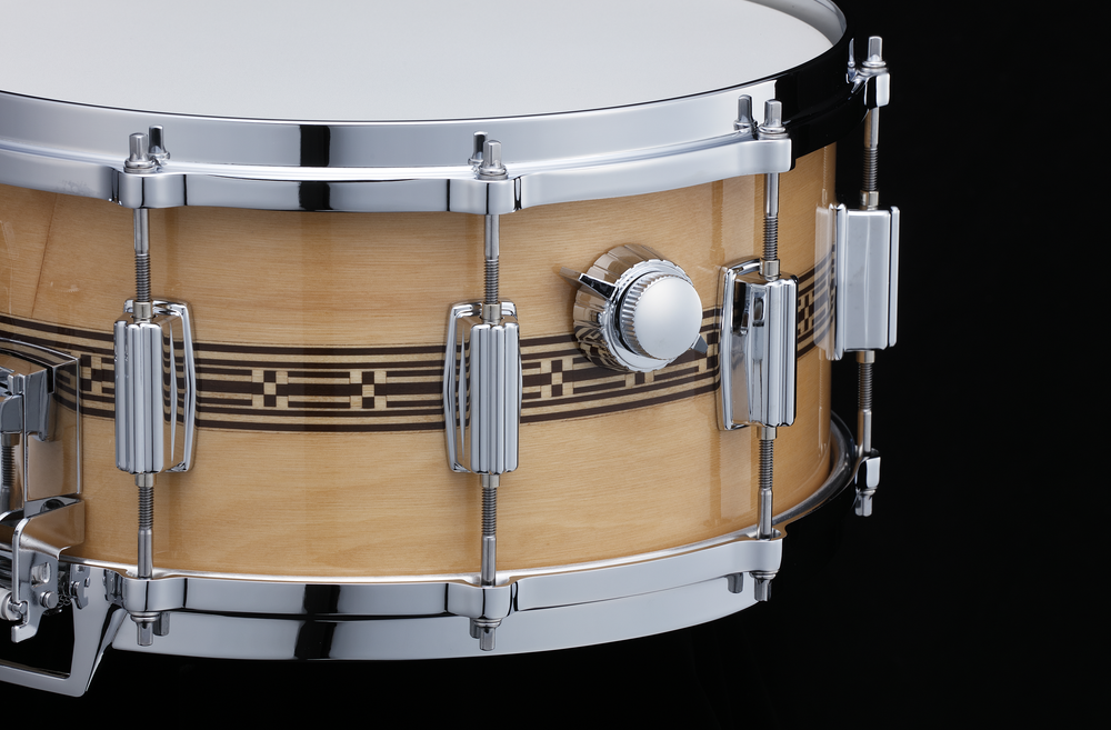 Tama 50th Limited Mastercraft Artwood 14x6.5 snare drum showing wooden shell and metal hardware with drumsticks.