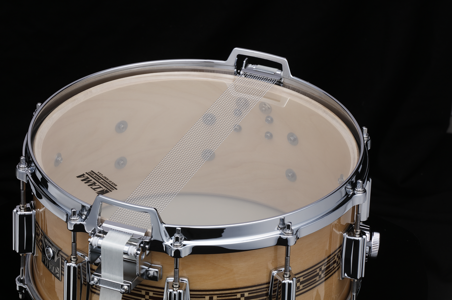 Tama 50th Limited Mastercraft ARTWOOD 14x6.5 inch snare drum with wooden finish and metal hardware, showcasing intricate craftsmanship.