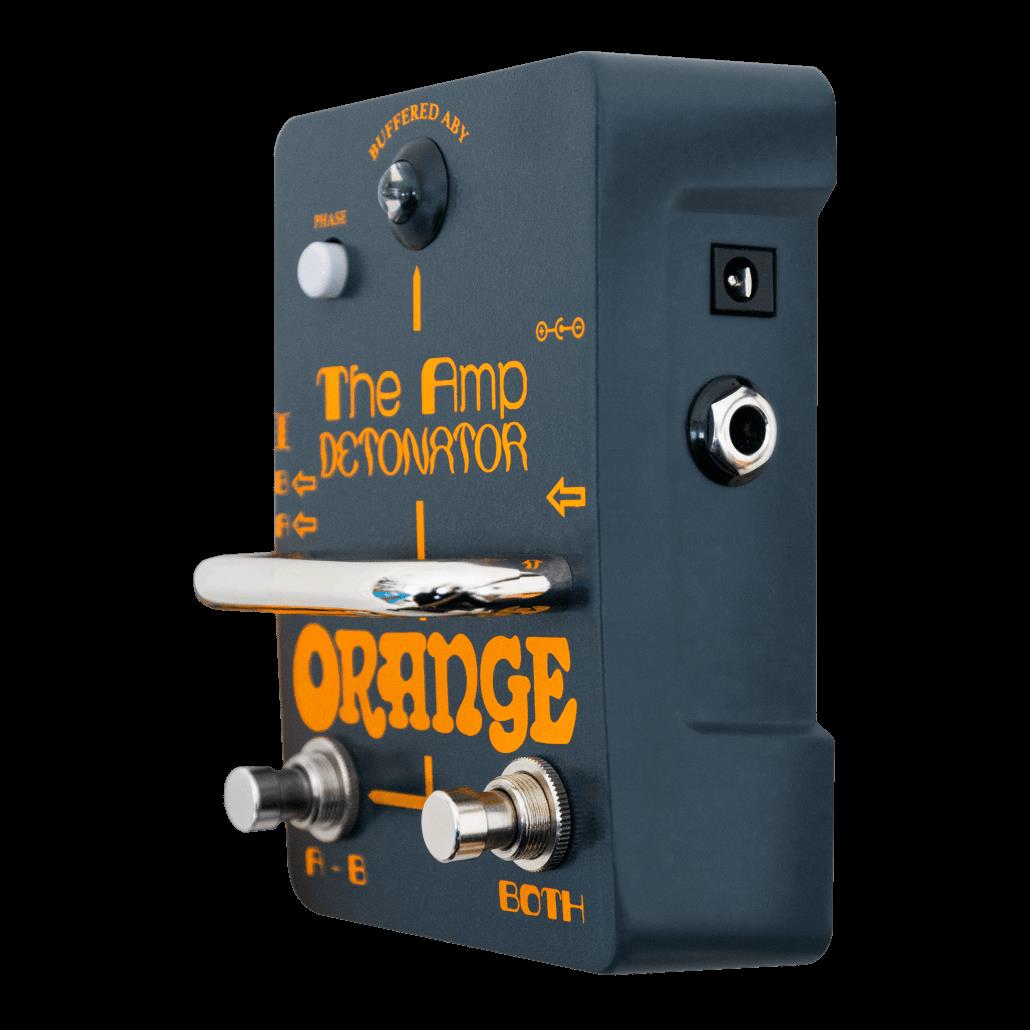 Orange Amp Detonator AB effects pedal for guitar, featuring orange casing and control knobs for sound switching.