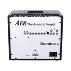 AER Domino 2 100W acoustic guitar amplifier with control knobs and speaker grille, designed for live music performances.