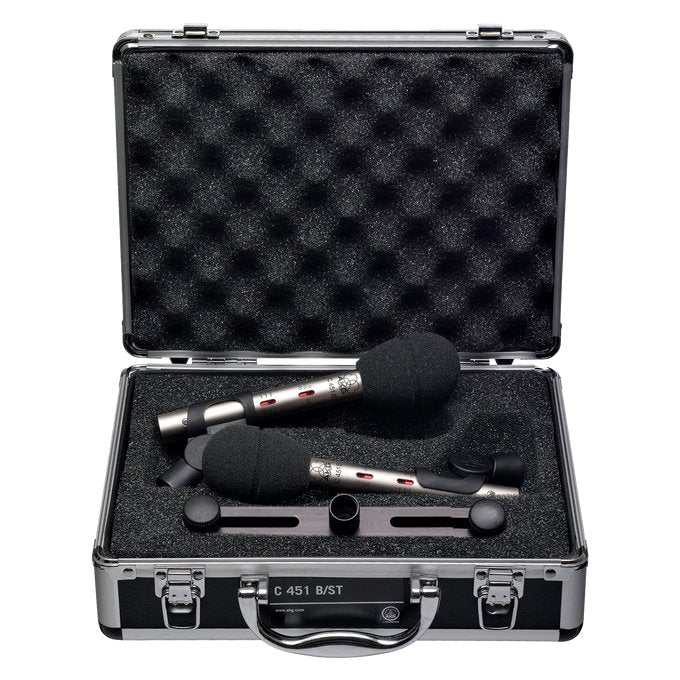 Pair of AKG C451B small diaphragm condenser microphones with protective case and stereo bar for studio recording.